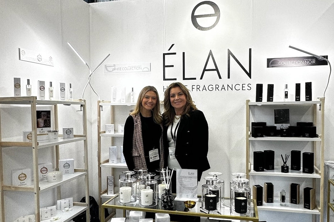 Sally Waters and Leia at the ÉLAN Home Fragrances studio wearing aprons while working on hand-poured candles.