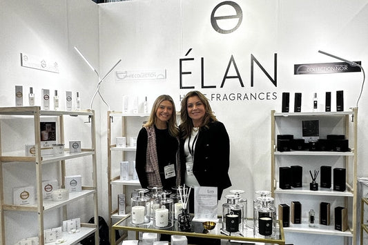 Sally Waters and Leia at the ÉLAN Home Fragrances studio wearing aprons while working on hand-poured candles.