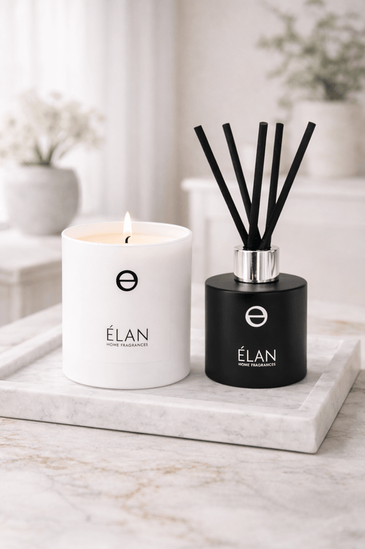Luxury fragrance layering with scented candles and reed diffusers in a modern living space