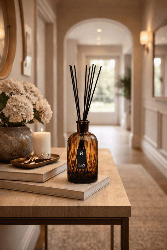 ÉLAN reed diffuser styled in an elegant hallway with floral accents