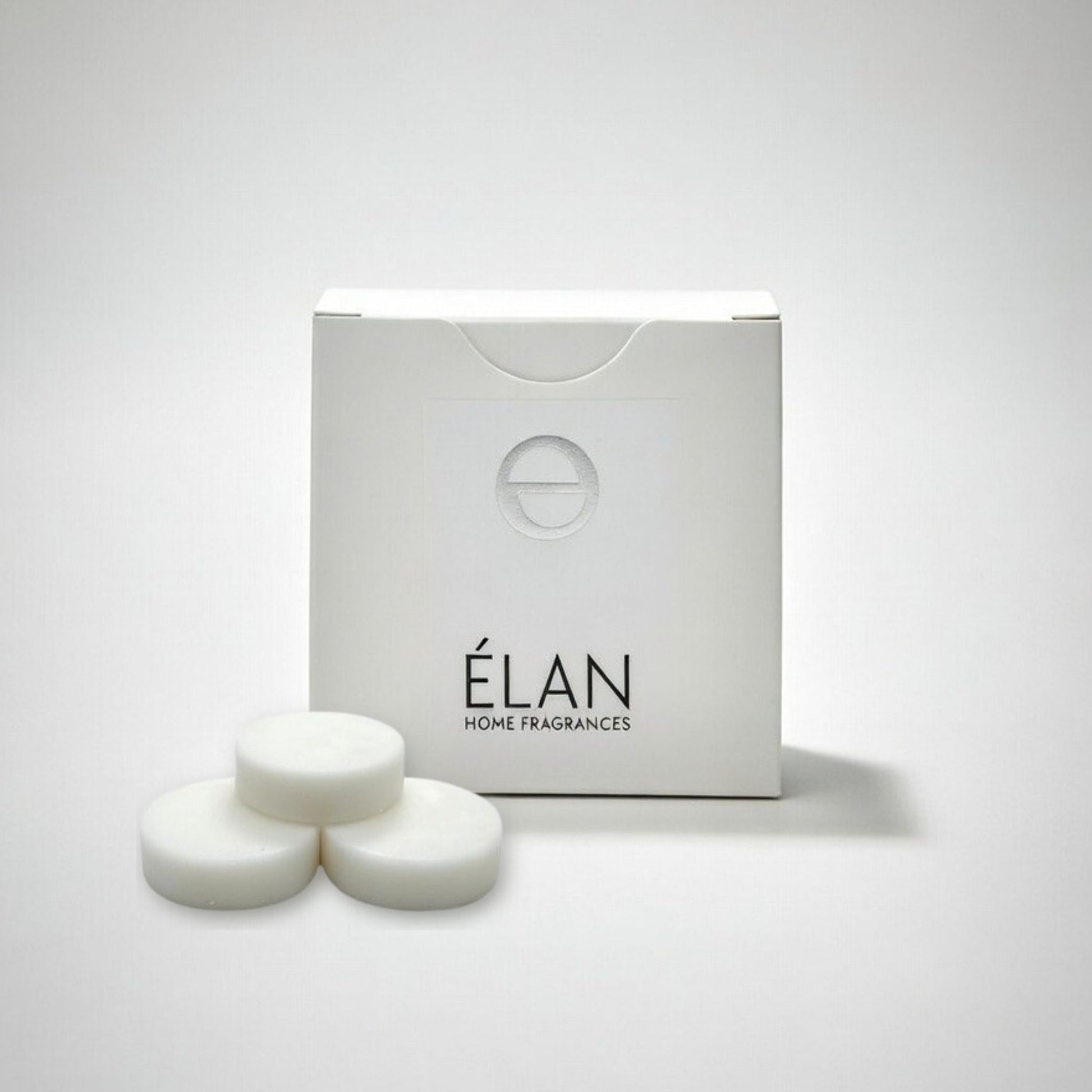 Elan home fragrances 3 wax melts in front of a white box on a light gray background